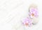 Two light pink orchids and stones on wooden shabby background