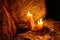 Two lighted candles stand on the rocks