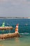 Two lighthouses, green, red, and white stripes at Praia da Batata, Lagos, Portugal