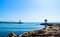 Two lighthouses located on the rocks of the breakwaters that protect the entrance to the marina