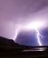 Two lightning bolts reflecting in water