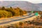 Two line wide highway bend on a colorful Autumn day