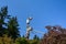 Two linemen working on a wireless communications radio and antenna installation using a bucket truck