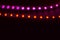 Two lines of red and purple neon lights on black