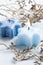 Two lit blue Christmas aroma candles