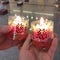 Two lit chinese praying candle for Chinese new year celebration held by couple lovers