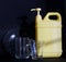 Two-liter yellow plastic canister with a pump dispenser and cleaning disinfectant liquid stands next to transparent clean dishes