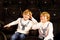 Two little adorable blonde kid boys waiting for a film at cinema. Siblings, twins and brothers having fun with activity