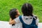 Two little asian girls sisters hugging happy post in school uniform, back to school concept