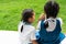 Two little asian girls sisters hugging happy post in school uniform, back to school concept