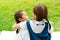 Two little asian girls sisters hugging happy post in school uniform, back to school concept