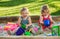 The two little baby girls playing toys in sand