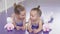 Two little ballerinas lying on the floor at ballet school resting after practicing