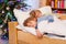 Two little blond sibling boys sleeping in bed on Christmas