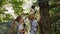 Two little boy in climbing gear is walking along a rope road in a Park.