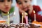 Two little boys blowing candles