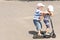 Two little boys enjoying a scooter ride