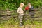 Two little boys having a discussion over a fence