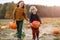 Two little boys having fun in a pumpkin patch