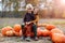 Two little boys having fun in a pumpkin patch