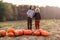 Two little boys having fun in a pumpkin patch