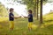 Two little boys, holding swords, glaring with a mad face at each