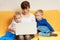 Two little boys and mother using laptop