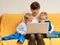 Two little boys and mother using laptop