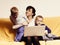 Two little boys and mother using laptop