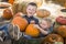 Two Little Boys Playing in Wheelbarrow at the Pumpkin Patch