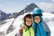 Two little boys with safety helmets and clothing with mountains landscape backgrounds. Kids hiking and discovering