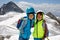 Two little boys with safety helmets and clothing with mountains landscape backgrounds. Kids hiking and discovering