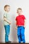 Two little boys siblings playing together on table