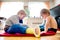 Two little boys sitting on the floor playing.