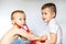 Two little boys using stethoscope. Children playing doctor and patient. Check the heartbeat.