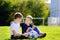 Two little brothers having fun playing a soccer game