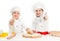 Two little chefs cutting dough with thumbs up