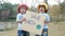 Two little child girl siblings holding `Save the planet` Poster showing a sign protesting against plastic pollution in the forest.