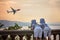 Two little children, boy brothers, looking at landing airplane i