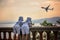 Two little children, boy brothers, looking at landing airplane i
