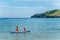 Two little children canoeing at tropical beach