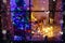 Two little children sitting by a fireplace at home on Christmas