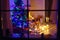 Two little children sitting by a fireplace at home on Christmas