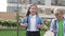 Two little classmates, a boy and a girl, are walking around the school yard in a good mood. School friendship.