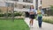 Two little classmates, a boy and a girl, are walking around the school yard in a good mood. School friendship.