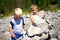 Two little cute boys together building tower of stones