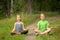 Two little cute yoga girls sitting in Lotus position