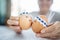 Two little easter eggs with a painted drawn rabbit faces and ears on them in the hands of a young boy teenager. Easter holidays