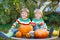 Two little friends boys making jack-o-lantern for halloween in a