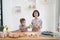 Two little girl cooks in the kitchen at home